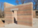 Example of a rammed earth wall showing the different coloured layers of earth