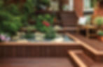 Outdoor multi-level deck made of recycled plastic lumber looks like wood, with garden