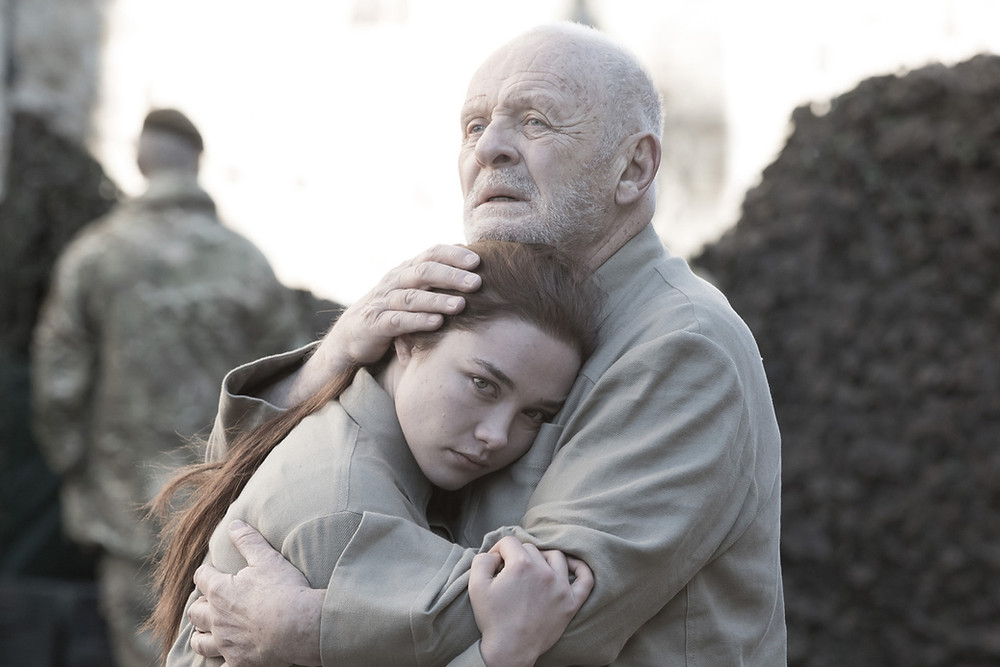 Actor Anthony Hopkins portraying King Lear embraces Florence Pugh, who plays Cordelia.