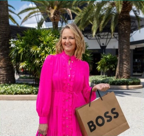 Louise Chambers Stylist in pink Sheike dress and Boss shopping bag at Harbour Town Gold Coast