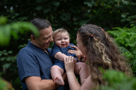 parents cradle son during photoshoot in woods