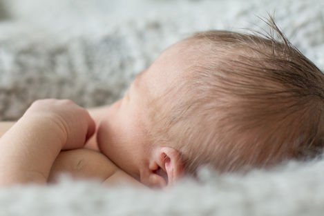 a close up of a baby 's head and ear