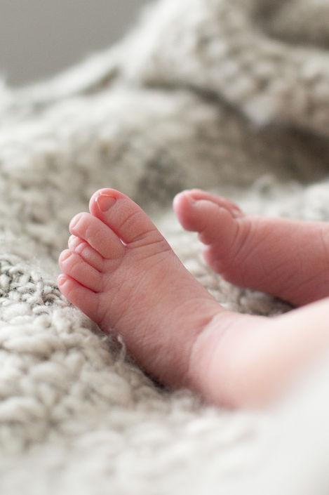 a close up of a baby 's feet on a blanket