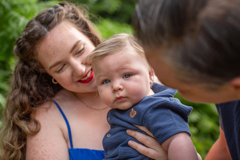 mum and dad hold baby boy