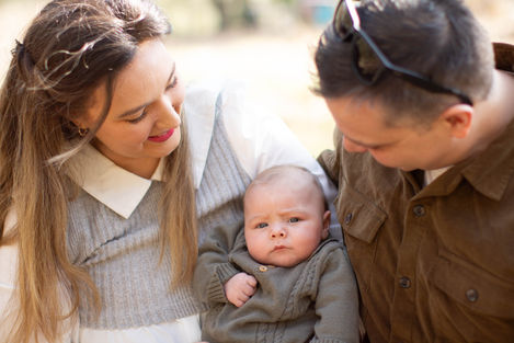 new parents holding baby son