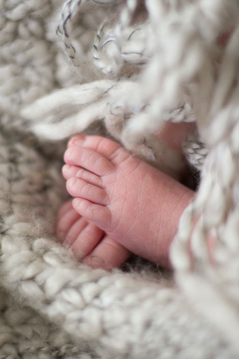 a close up of a baby 's foot on a blanket