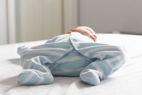 a baby is wearing a blue and white striped outfit