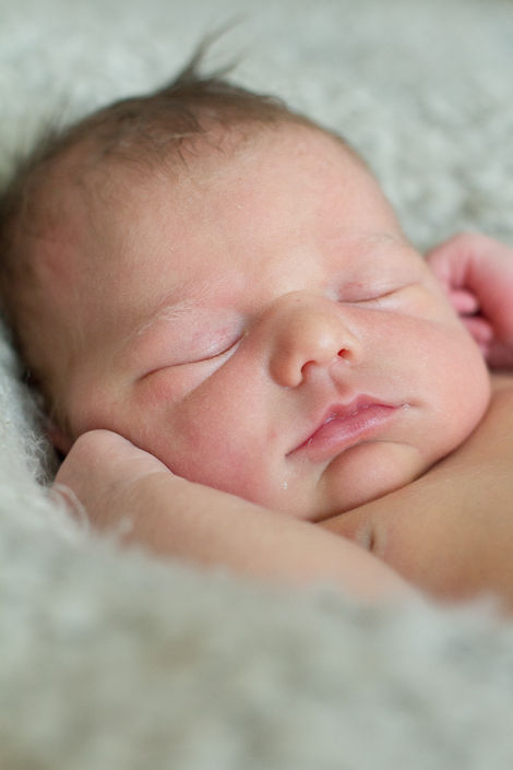 a close up of a baby sleeping on a blanket