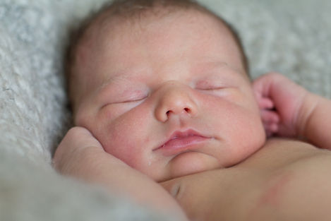 a close up of a baby sleeping with his eyes closed