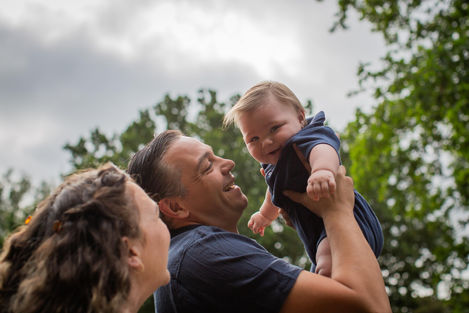 dad lifts son into the air