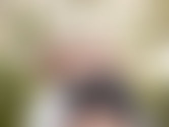 mum holding young daughter in green woodland setting