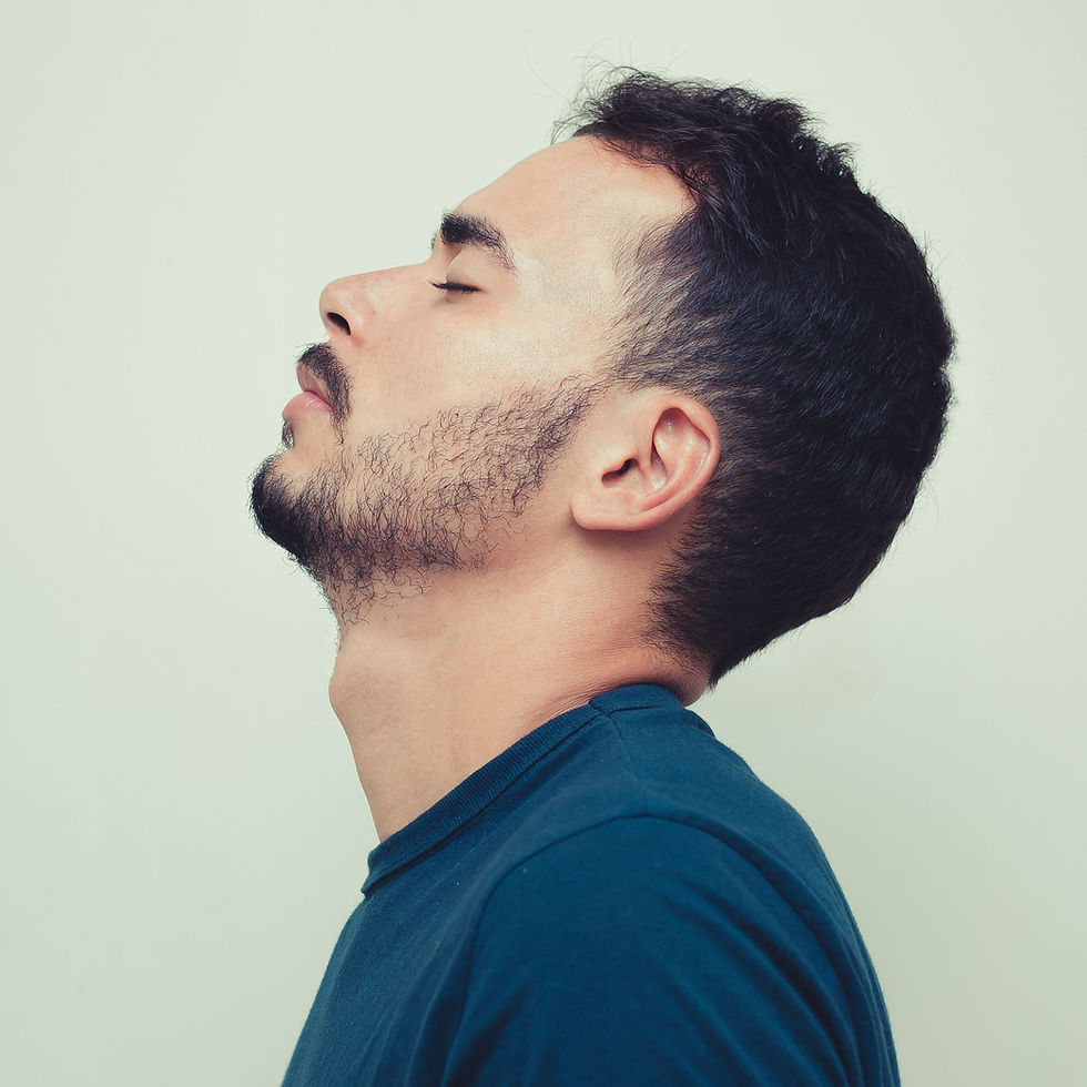 Side profile of man with enhanced jawline after filler treatment