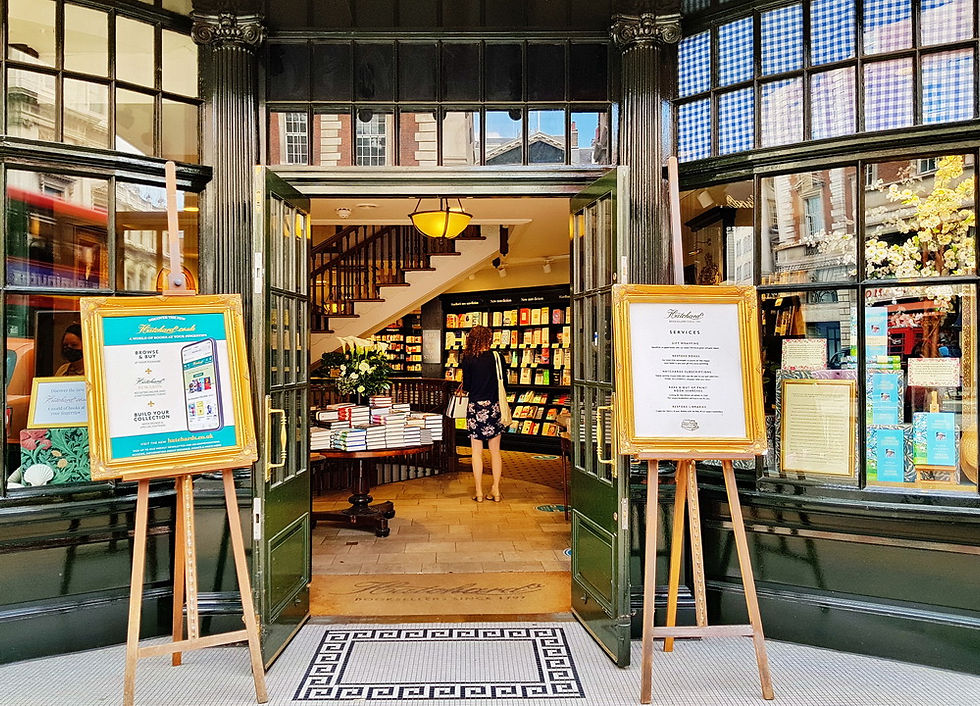 Hatchards’ spectacularly Dickensian moss green entrance framed by wooden frames and curved bay windows.