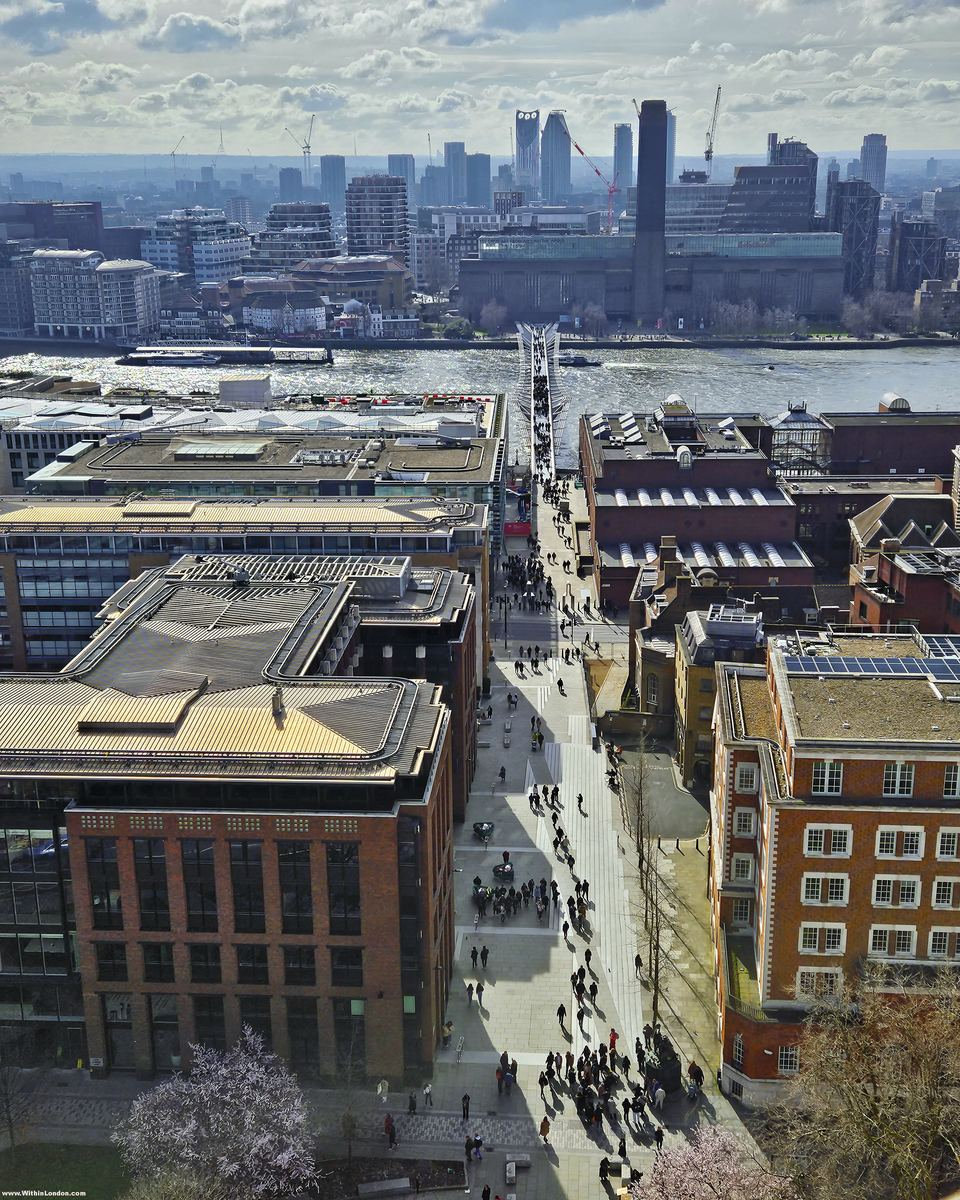 The Millennium Bridge crossing the Thames to Tate Modern's brick chimney, seen from the dome of St Paul's