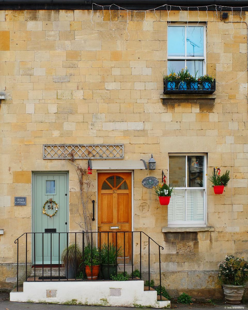 Grace Cottage's pale green door with an Easter wreath, set in a honey-stone Winchcombe facade