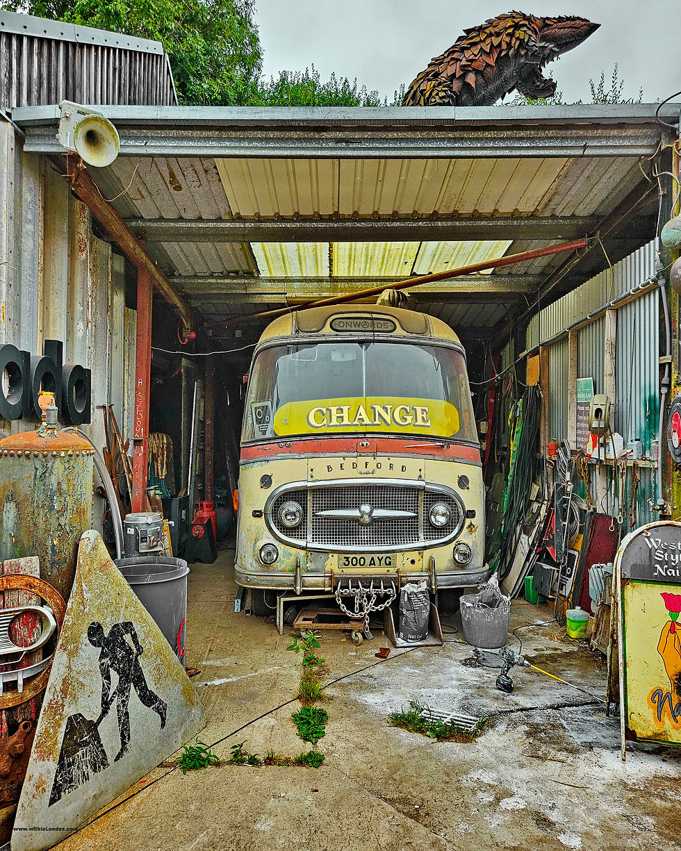 Vintage Bedford bus parked inside a workshop garage at Rockaway Park, Somerset