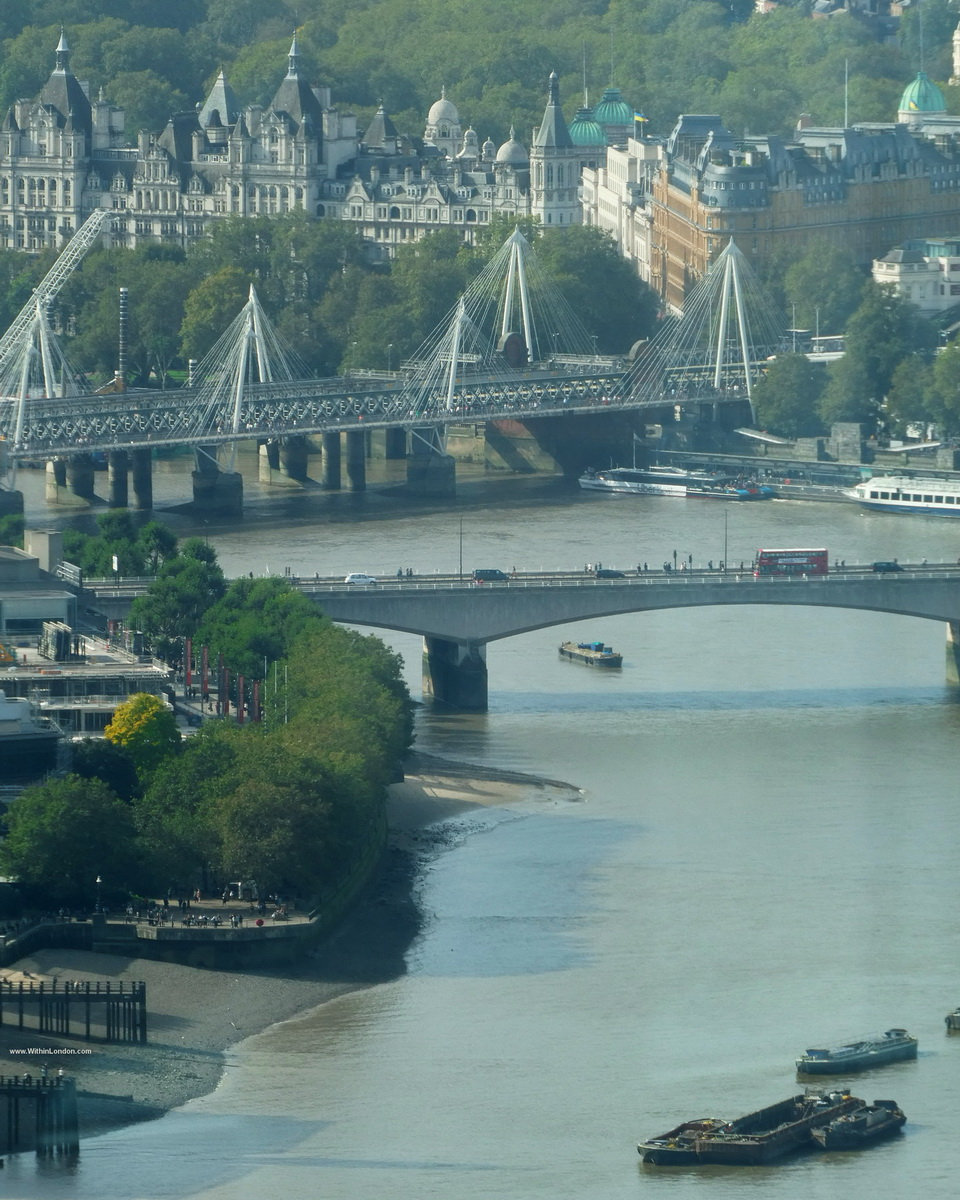 The Thames curving past the Shard and Tower Bridge, seen through the glass of the 50th-floor Lookout at 8 Bishopsgate