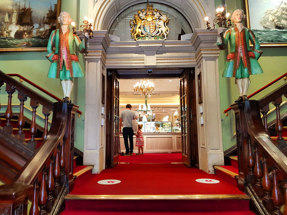 Fortnum and Mason side entrance (Duke Street) with a beautiful wooden staircase decorated with statues