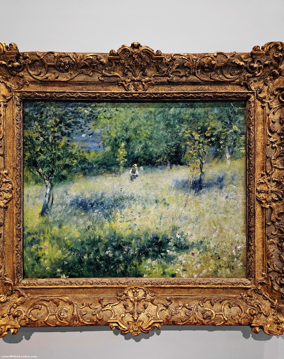Renoir painting of a sunlit spring meadow with young trees and a small figure, in an ornate gold frame