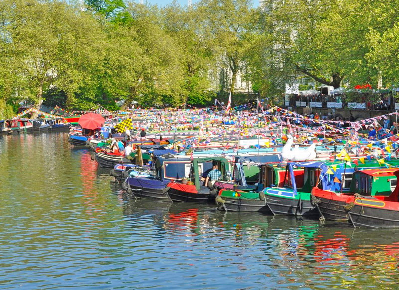 Canal boats decorated for the annual Canalway Cavalcade waterways festival in Little Venice, London.