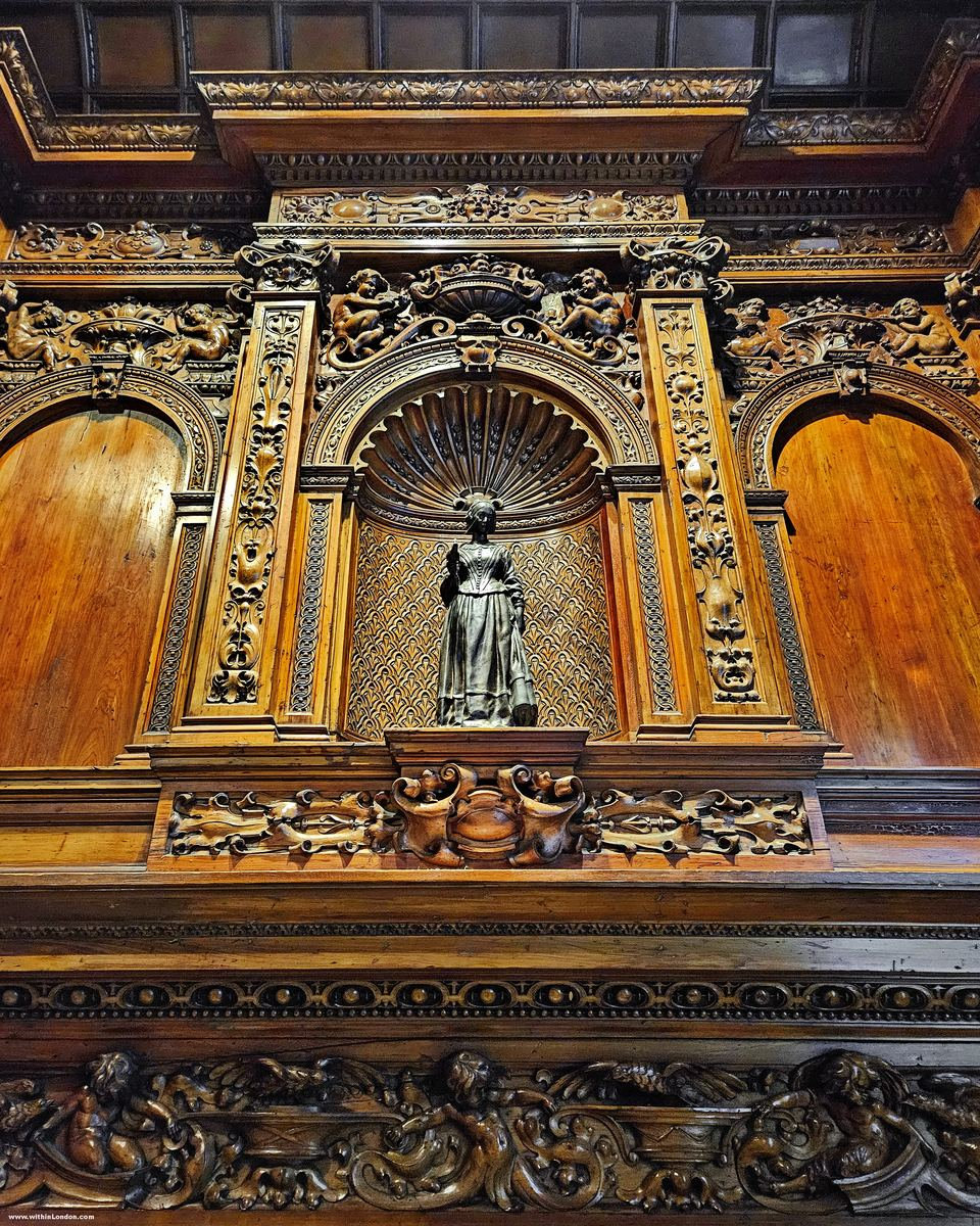 Gilded carved wooden panel with a small bronze figure standing in a niche