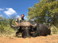 Male hunter with Cape Buffalo trophy in South Africa
