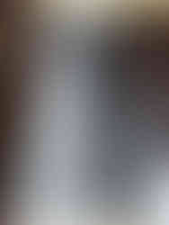 Close-up of concrete bridge column wrapped in carbon fiber showing tight, glossy surface finish.