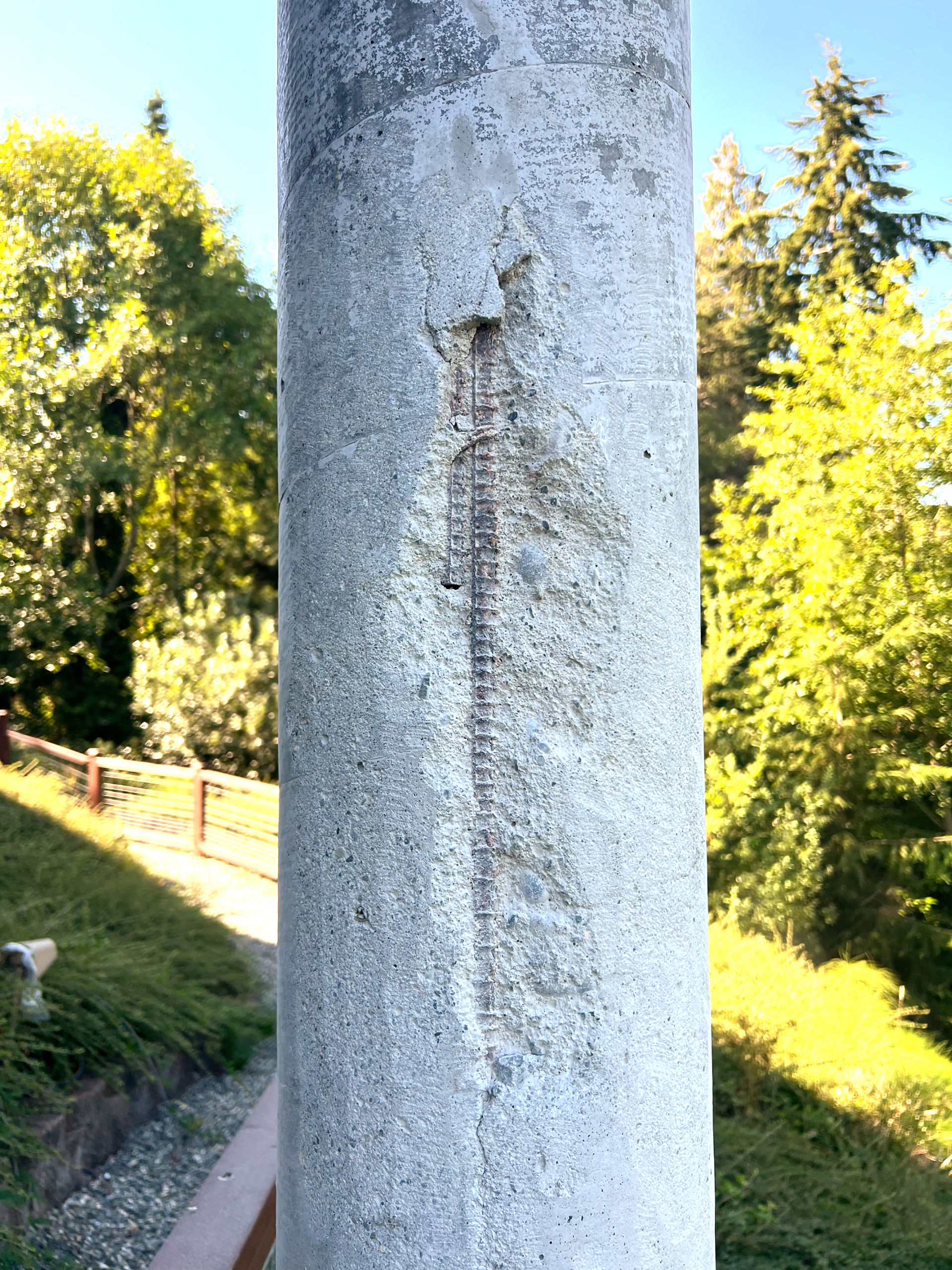 Concrete column with large portion exposed to the reinforcing steel on the inside. 