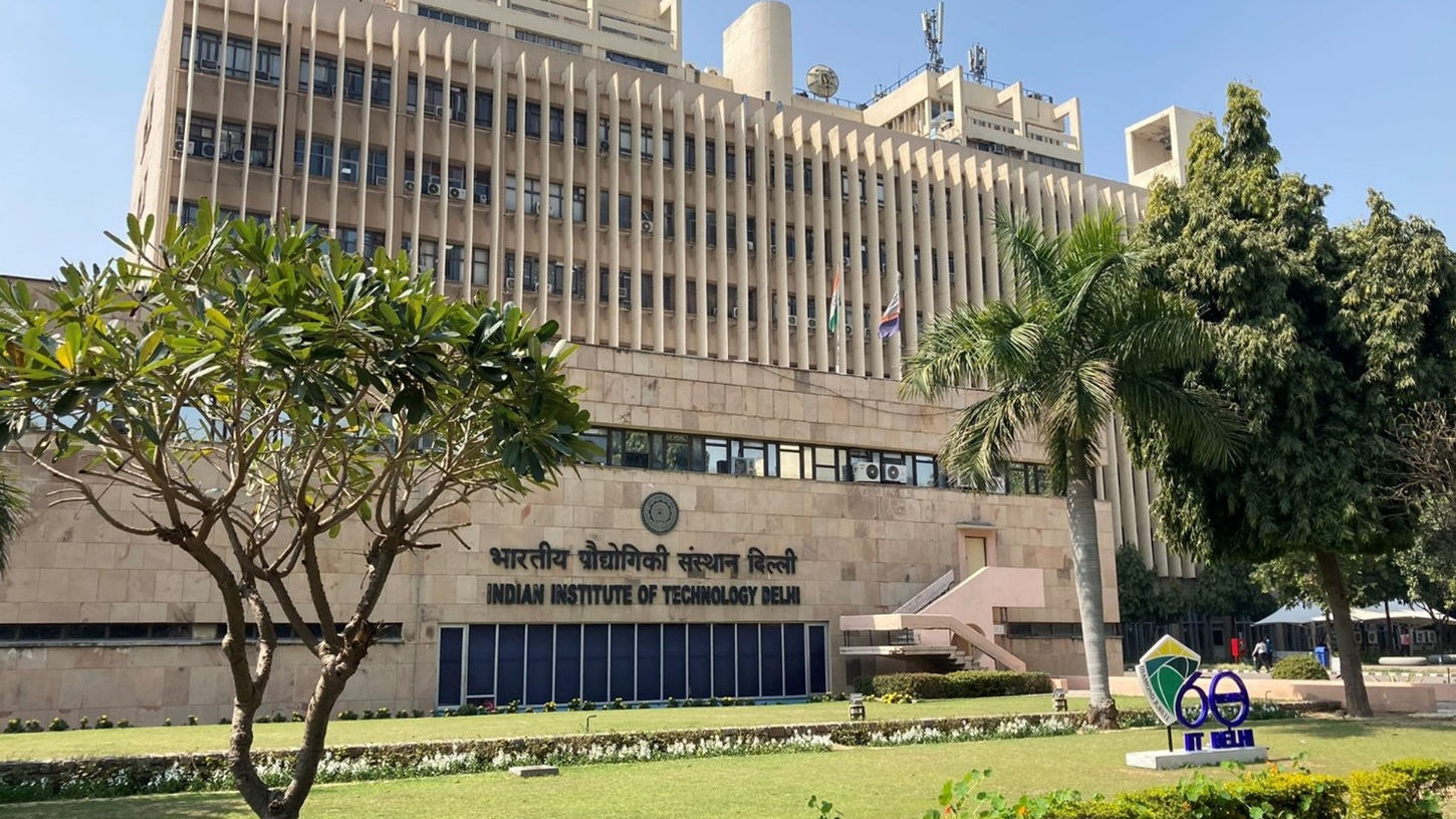 IIT Delhi administrative building exterior with airplane overhead