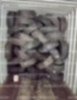 Many tires stacked inside a shipping container