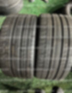 Two used tires, tread patterns visible