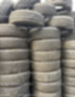 Large stacks of dirty used tires