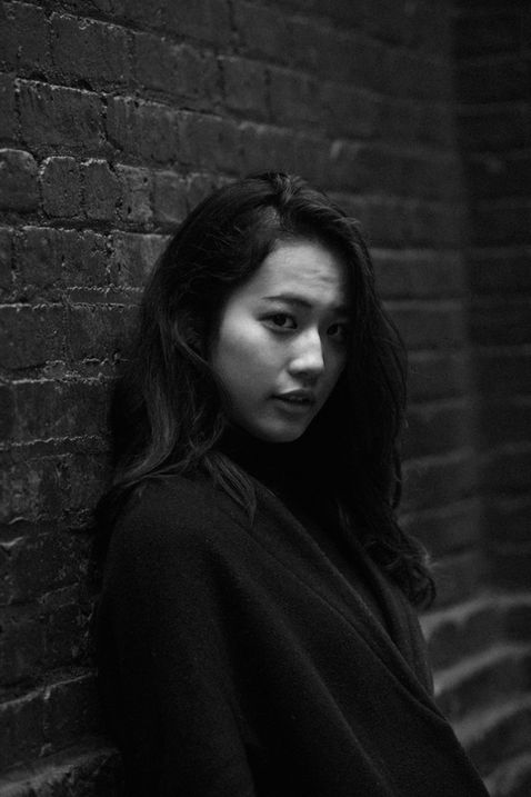 Portrait schwarz-weiss Frau an einer Mauer