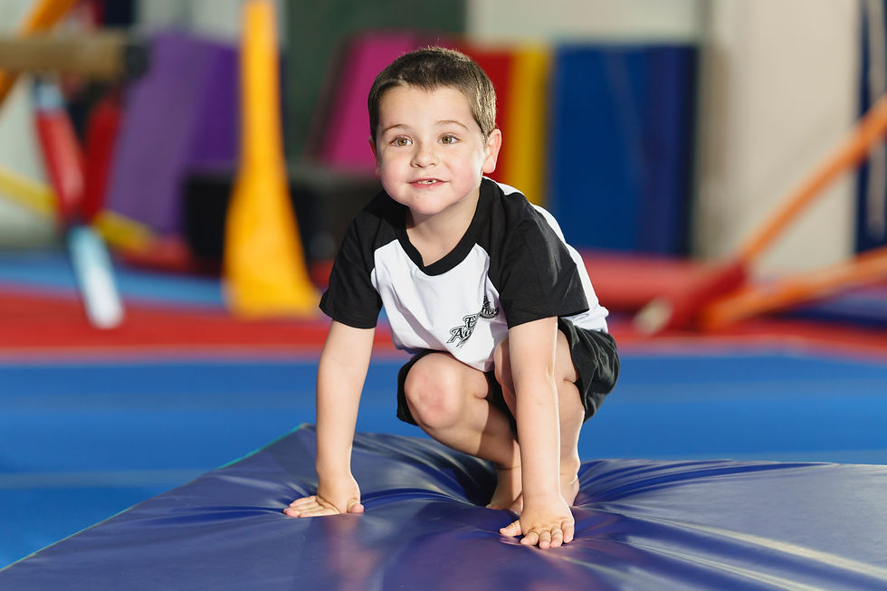 Child practicing a forward roll at gymnastics at EKGA - how this helps with for school readiness