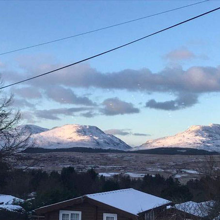 A view of snowy Rhinogydd mountains from Hedd Wyn log cabin - a Cadair View Lodge managed property in Snowdonia