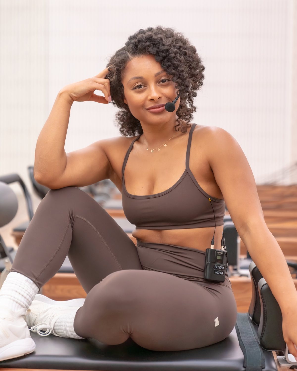 Robin Roby smiling on a Pilates Reformer