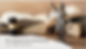 A gavel, a table statue of the Lady of Justice holding scales in one hand and a sword in the other hand and two open books and one closed book arranged on a table.