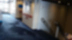 Empty ferry hallway with blue carpet, white walls, and a staircase labeled "8" leading down. Red handrails and emergency equipment visible.