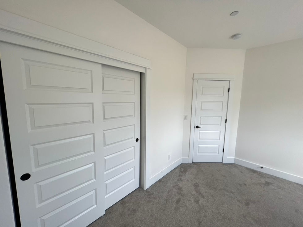 Close-up of professionally spray-painted white interior doors and door frames in Beaverton home.