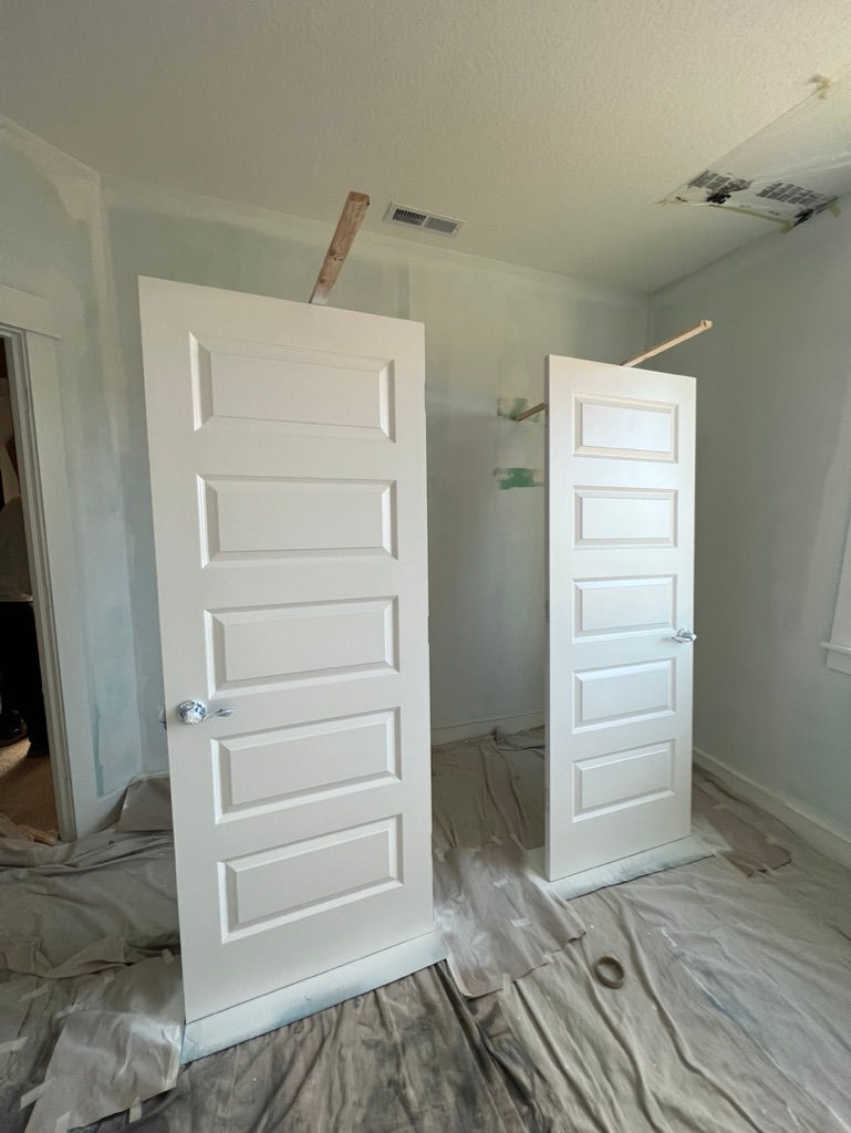 Professional spray-painted white interior doors in a Hillsboro, Oregon home, featuring a smooth fine-finish and crisp architectural details.