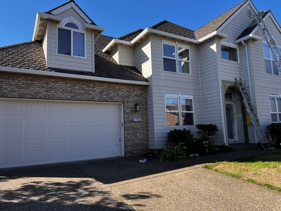 Professional exterior home painting in NW Portland featuring a modern grey and white color palette, precision caulking for moisture protection, and a premium weather-shielding finish by Amazing Painting & Renovation.
