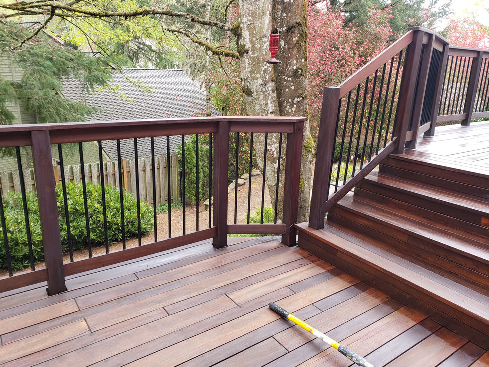 Professional cedar wood porch staining and black metal railing installation in Tualatin, Oregon, by Amazing Painting & Renovation.