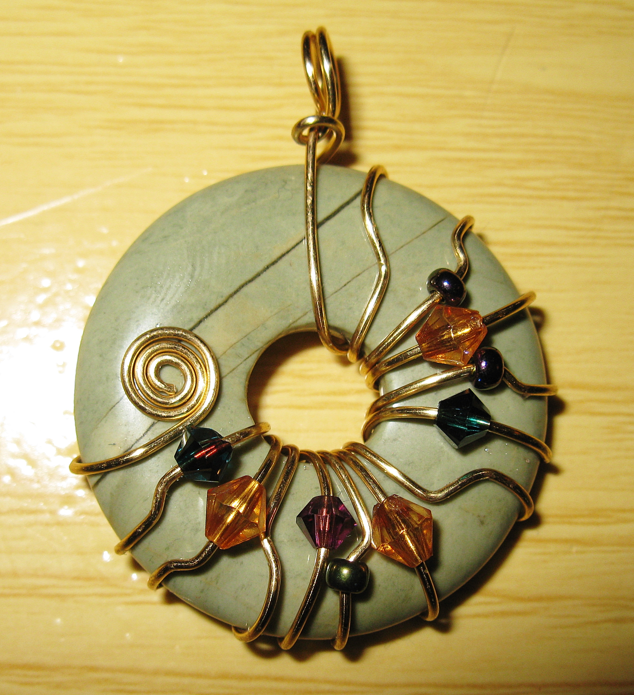 Asymmetrical donut wrap pendant