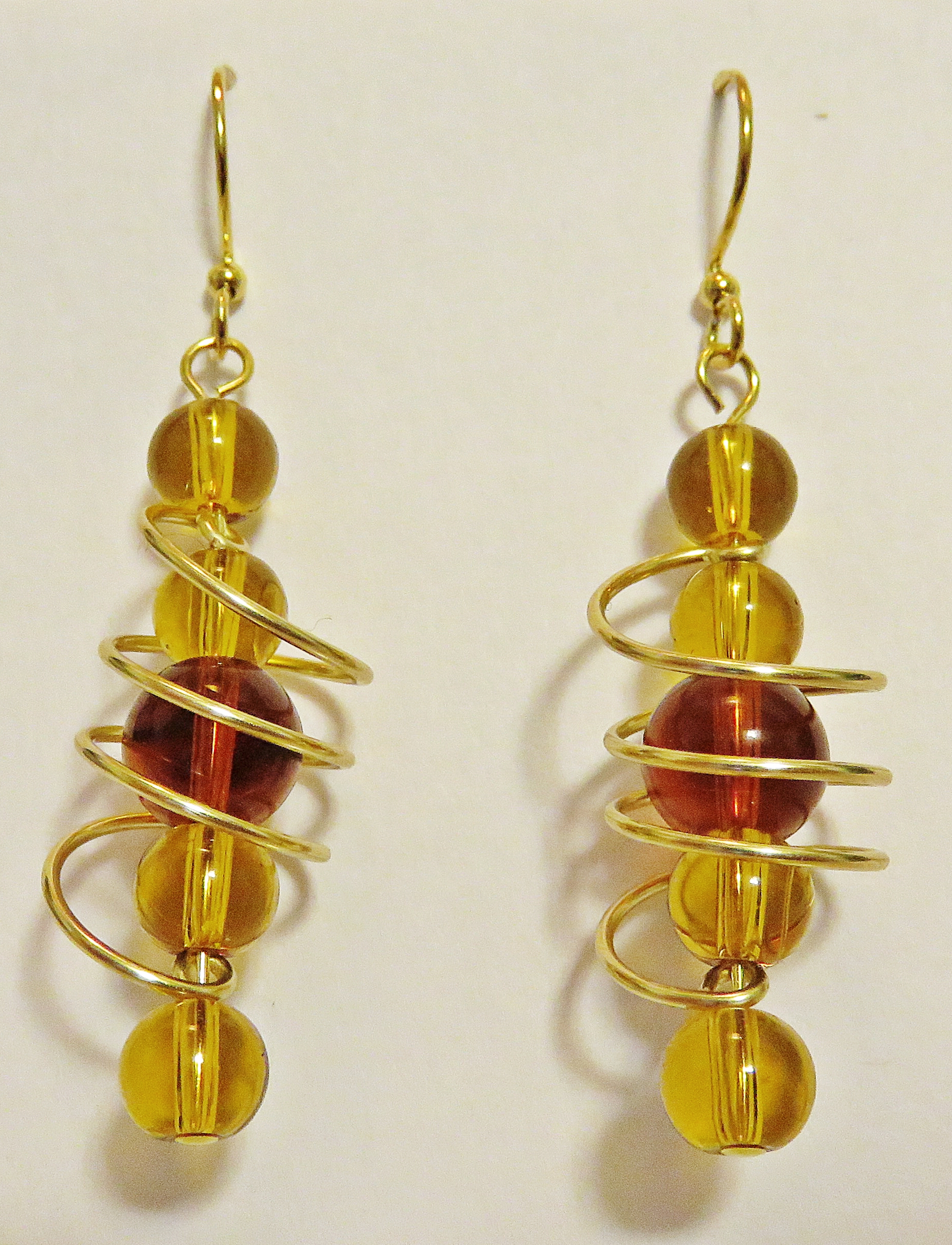 Amber-coloured freeform coil earring