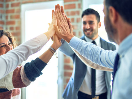 A team of people high-fiving.