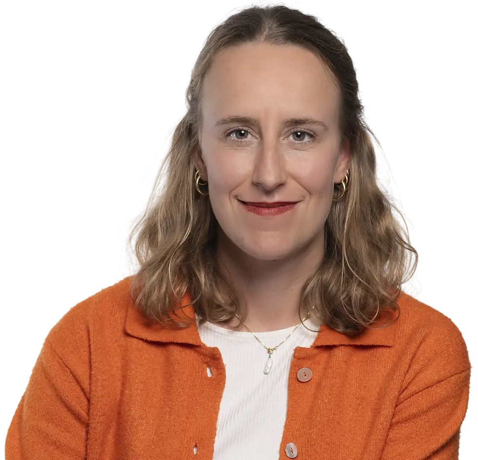 Studio portrait of a smiling woman against a solid black background. The professional composition highlights her warm expression.