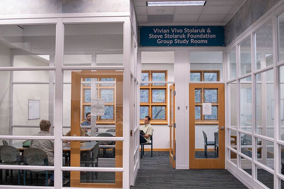 Two groups of people sit in study rooms with large windows and a bright atmosphere.
