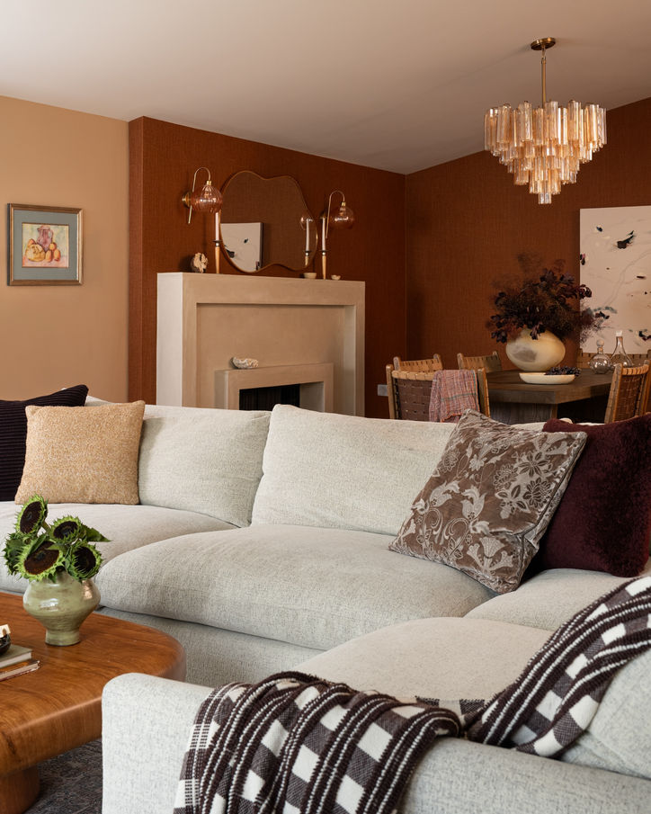 View from the living room into the Mossbank dining room with layered burgundy, cream and natural wood tones.