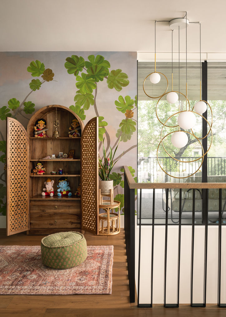 Upstairs landing in an Austin home with botanical wallpaper, a carved wood cabinet and garden views.