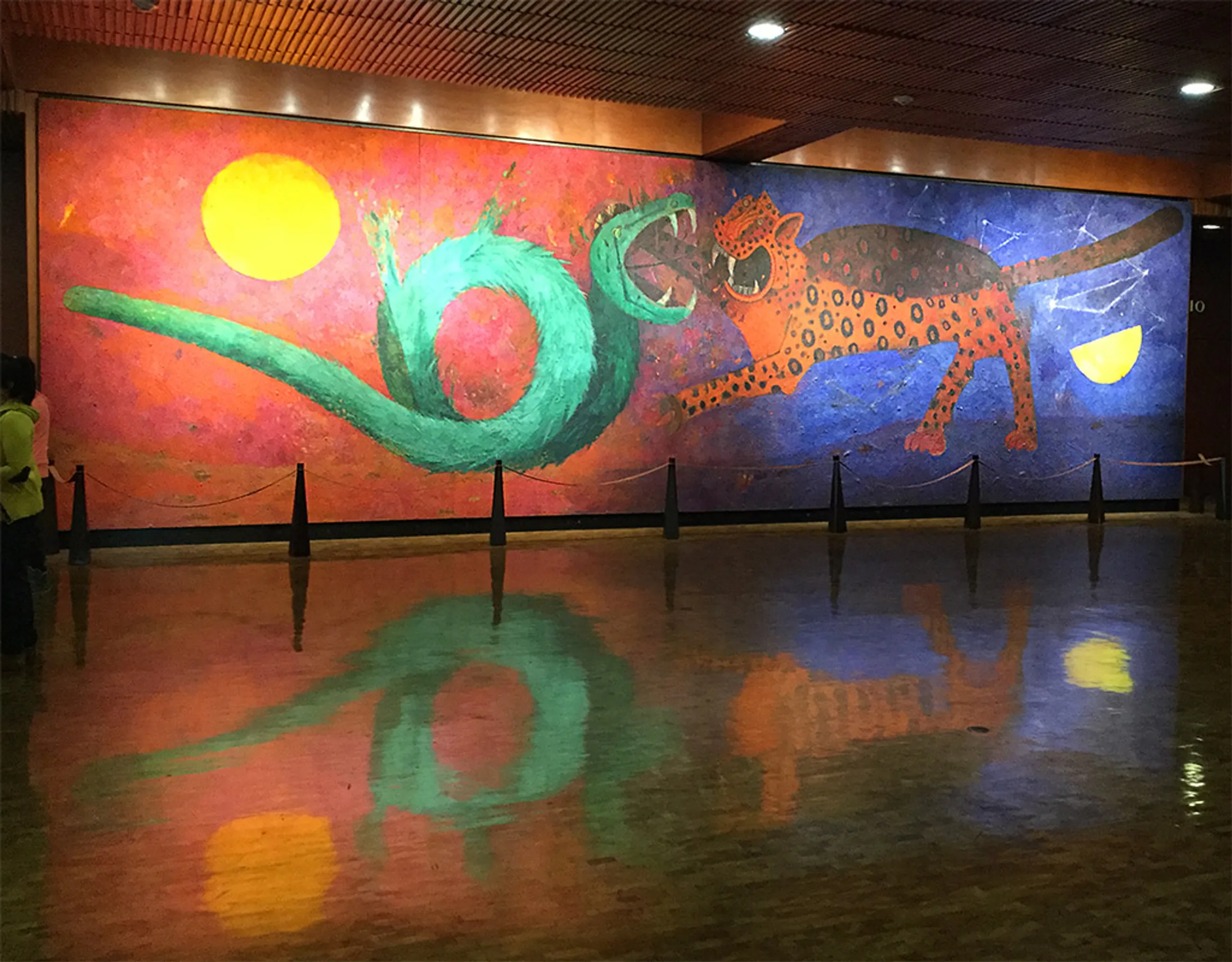 a mural from Rufino Tamayo called Duality where a jaguar and a snake are figthing each other, the jaguar represents the night and the snake the sun.